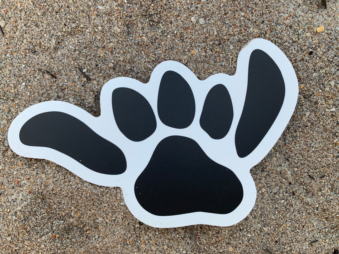 Salty Paws Shaka Paw die-cut sticker — black with white outline, surf dog brand