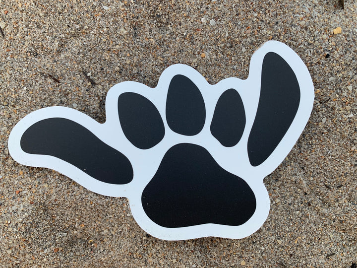 Salty Paws Shaka Paw die-cut sticker — black with white outline, surf dog brand